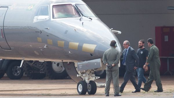 The former president of the Chamber of Deputies Eduardo Cunha, is escorted to a Federal Police's plane, departing to Curitiba where he should fulfill his provisionally arrest, which was issued this morning, at the Hangar of the Federal Police in Brasilia The former president of the Chamber of Deputies Eduardo Cunha, is escorted to a Federal Police's plane, departing to Curitiba where he should fulfill his provisionally arrest, which was issued this morning, at the Hangar of the Federal Police in Brasilia - Sputnik International