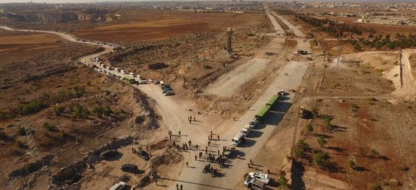 Law enforcement officers near cars and ambulances in a humanitarian corridor along the Castello Road in northern Aleppo, Syria Law enforcement officers near cars and ambulances in a humanitarian corridor along the Castello Road in northern Aleppo, Syria - Sputnik International