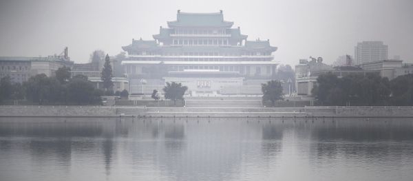 A North Korean man makes his way along the Taedong River where the Kim Il Sung Square and the Grand People's Study House are seen on the other side in Pyongyang, North Korea - Sputnik International