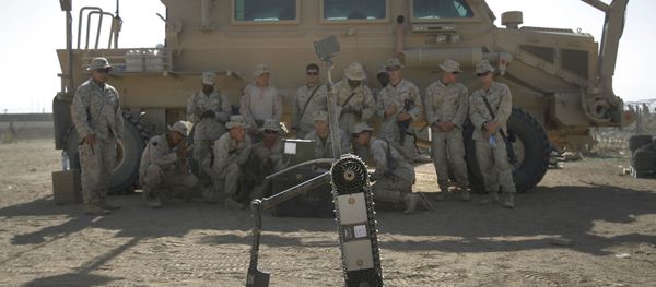 US Marines from the 2nd Marine Expeditionary Brigade are taught how to use a robot to search for improvised explosive devices during training lesson at Camp Leatherneck in Afghanistan's Helmand province Tuesday June 9, 2009. - Sputnik International