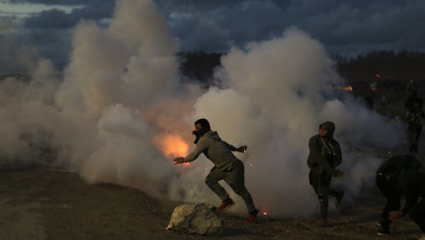 Demonstrators throw back tear gas canisters to French riot police officers during clashes in a makeshift migrant camp known as the jungle near Calais, northern France, on Saturday, Oct. 22, 2016 Demonstrators throw back tear gas canisters to French riot police officers during clashes in a makeshift migrant camp known as the jungle near Calais, northern France, on Saturday, Oct. 22, 2016 - Sputnik International