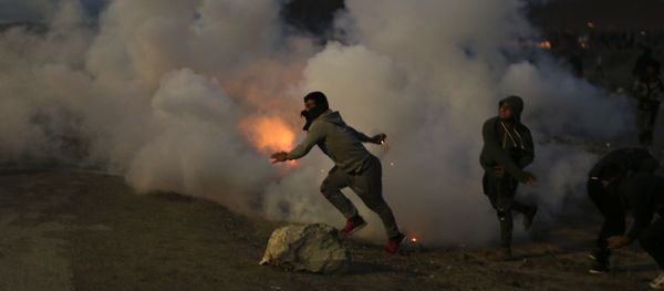 Demonstrators throw back tear gas canisters to French riot police officers during clashes in a makeshift migrant camp known as the jungle near Calais, northern France, on Saturday, Oct. 22, 2016 Demonstrators throw back tear gas canisters to French riot police officers during clashes in a makeshift migrant camp known as the jungle near Calais, northern France, on Saturday, Oct. 22, 2016 - Sputnik International