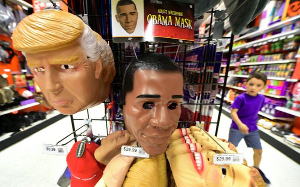 A child walks past a display of masks of US President Barack Obama, and presidential hopefuls Donald Trump and Hillary Clinton, for sale at a shop selling Halloween items in Alhambra, California on October 21, 2016 A child walks past a display of masks of US President Barack Obama, and presidential hopefuls Donald Trump and Hillary Clinton, for sale at a shop selling Halloween items in Alhambra, California on October 21, 2016 - Sputnik International