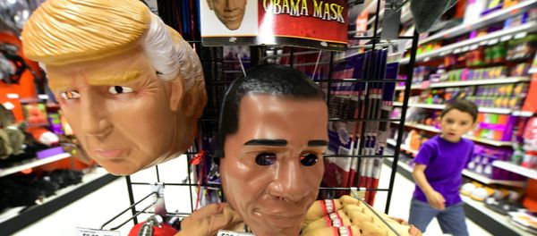A child walks past a display of masks of US President Barack Obama, and presidential hopefuls Donald Trump and Hillary Clinton, for sale at a shop selling Halloween items in Alhambra, California on October 21, 2016 A child walks past a display of masks of US President Barack Obama, and presidential hopefuls Donald Trump and Hillary Clinton, for sale at a shop selling Halloween items in Alhambra, California on October 21, 2016 - Sputnik International