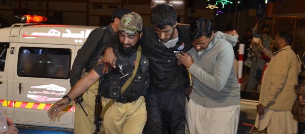 A Pakistani volunteer and a police officer rush an injured person to a hospital in Quetta, Pakistan, Monday, Oct. 24, 2016, after two separate attacks in Pakistan A Pakistani volunteer and a police officer rush an injured person to a hospital in Quetta, Pakistan, Monday, Oct. 24, 2016, after two separate attacks in Pakistan - Sputnik International
