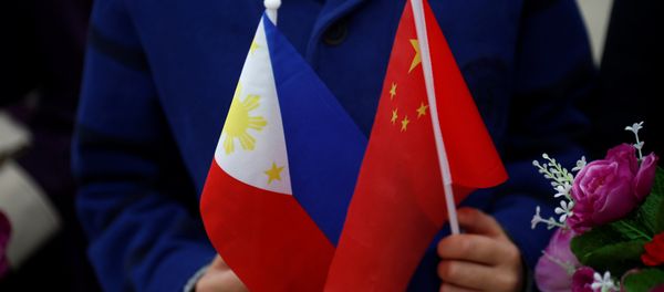 Children hold plastic flowers, national flags of China and the Philippines before President of the Philippines Rodrigo Duterte and China's President Xi Jinping attend a welcoming ceremony at the Great Hall of the People in Beijing, China, October 20, 2016 Children hold plastic flowers, national flags of China and the Philippines before President of the Philippines Rodrigo Duterte and China's President Xi Jinping attend a welcoming ceremony at the Great Hall of the People in Beijing, China, October 20, 2016 - Sputnik International