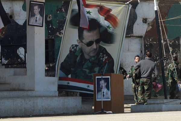 Banners with the portrait of Syrian President Bashar al-Assad at a self-defense fighters' training center near Damascus - Sputnik International