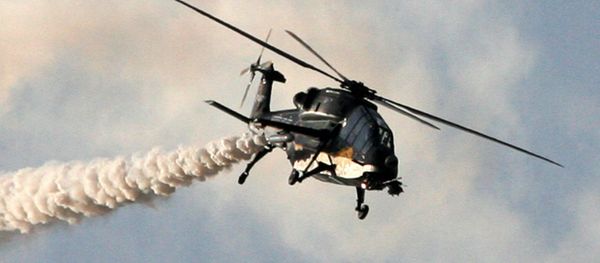 This handout photograph released by the Ministry of Defence on February 20, 2013, shows a HAL Black Tiger Light Combat Helicopter (LCH) performing a flypast during a full dress rehearsal for the Indian Air Force's Iron Fist 2013 military exercicse in Pokhran, near Jaisalmer in India's Rajasthan state, on February 19, 2013 - Sputnik International