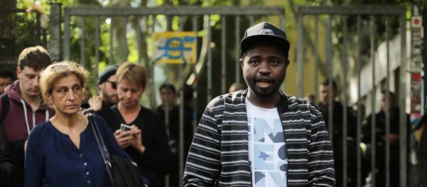 Sudanese refugees, who said their names are Adam, center, and Anour, right, speak to media in front of the entrance of the occupied Gerhart Hauptmann School in Berlin, Germany, Friday, June 27, 2014 Sudanese refugees, who said their names are Adam, center, and Anour, right, speak to media in front of the entrance of the occupied Gerhart Hauptmann School in Berlin, Germany, Friday, June 27, 2014 - Sputnik International