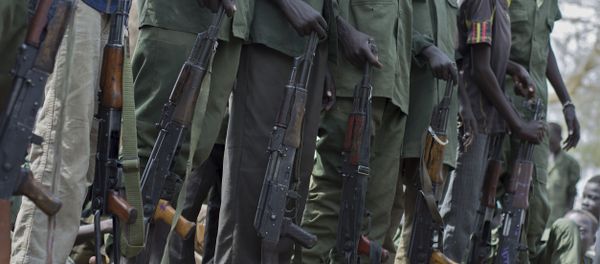 Young boys, children soldiers sit on February 10, 2015 prepare to lay down their arms at a ceremony of the child soldiers disarmament, demobilisation and reintegration in Pibor oversawn by UNICEF and partners Young boys, children soldiers sit on February 10, 2015 prepare to lay down their arms at a ceremony of the child soldiers disarmament, demobilisation and reintegration in Pibor oversawn by UNICEF and partners - Sputnik International