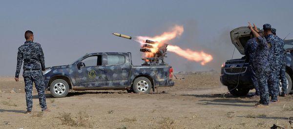 Federal police forces launch a rocket during clashes with Islamic State militants in south of Mosul Federal police forces launch a rocket during clashes with Islamic State militants in south of Mosul - Sputnik International