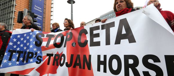 Demonstrators protest against the Comprehensive Economic and Trade Agreement CETA, a planned EU-Canada free trade agreement, outside the European Commission headquarters in Brussels, Belgium, October 27, 2016. Demonstrators protest against the Comprehensive Economic and Trade Agreement CETA, a planned EU-Canada free trade agreement, outside the European Commission headquarters in Brussels, Belgium, October 27, 2016. - Sputnik International