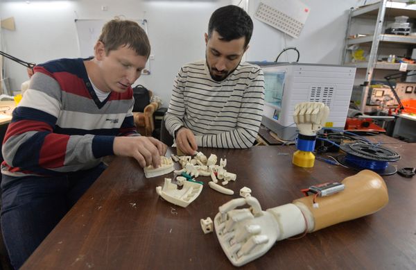 Belarussian programmer Oleg Galtsev (right) who made an electromechanical arm prosthetis for his father and his colleague Sergei Arefyev, constructor engineer Belarussian programmer Oleg Galtsev (right) who made an electromechanical arm prosthetis for his father and his colleague Sergei Arefyev, constructor engineer - Sputnik International