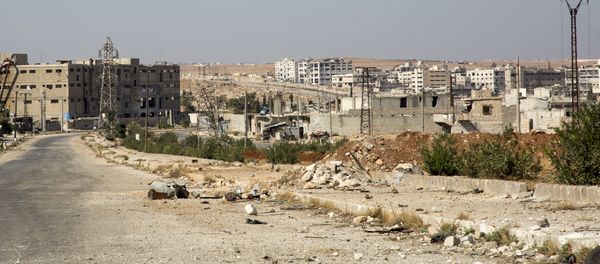 A general view shows a damaged road and abandoned buildings in Aleppo's militant-held Kalasa neighbourhood - Sputnik International