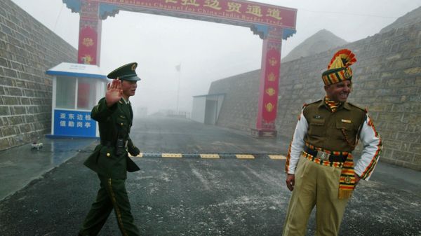 Chinese soldier (L) and an Indian soldier stand guard at the Chinese side of the ancient Nathu La border crossing between India and China. - Sputnik International