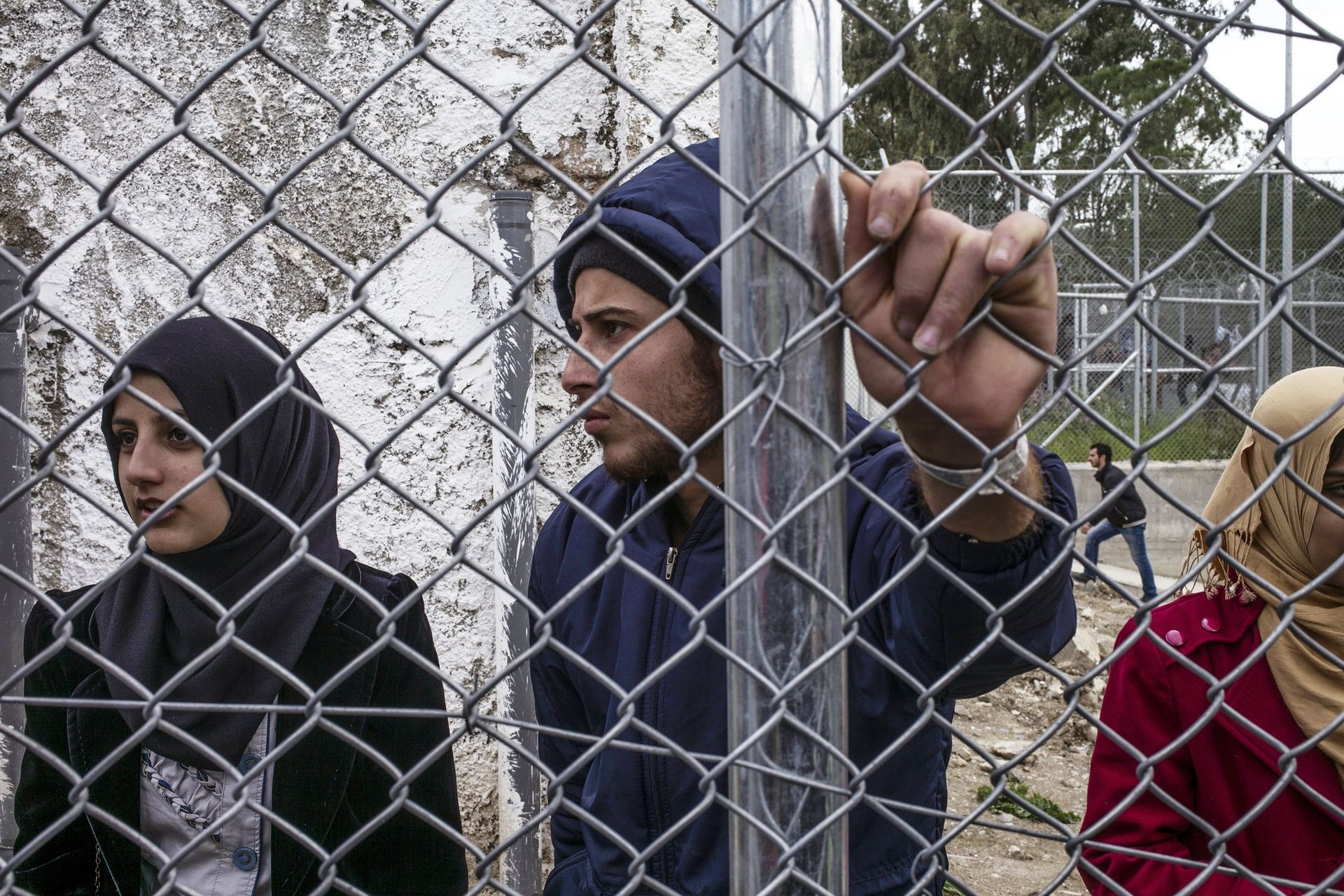 Syrian refugees stand inside the Moria camp during the demostration against the deal between EU and Turkey, on March 24, 2016 in Lesbos.  - Sputnik International, 1920, 21.09.2022