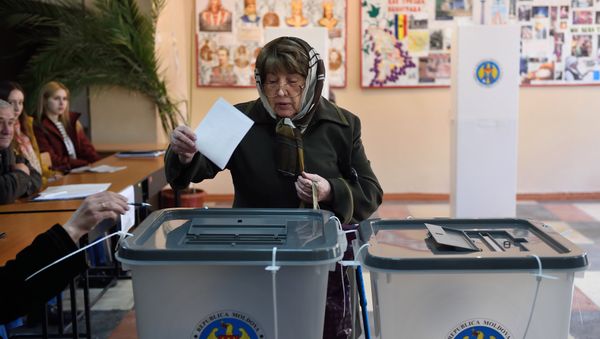 A woman casts her ballot for the presidential election at a polling station in Chisinau city A woman casts her ballot for the presidential election at a polling station in Chisinau city - Sputnik International