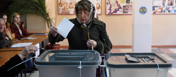 A woman casts her ballot for the presidential election at a polling station in Chisinau city A woman casts her ballot for the presidential election at a polling station in Chisinau city - Sputnik International