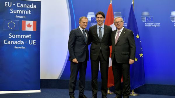 Canada's Prime Minister Justin Trudeau poses with European Council President Donald Tusk (L) and European Commission President Jean-Claude Juncker (R) before signing the Comprehensive Economic and Trade Agreement (CETA) at the European Council in Brussels, Belgium, October 30, 2016. Canada's Prime Minister Justin Trudeau poses with European Council President Donald Tusk (L) and European Commission President Jean-Claude Juncker (R) before signing the Comprehensive Economic and Trade Agreement (CETA) at the European Council in Brussels, Belgium, October 30, 2016. - Sputnik International