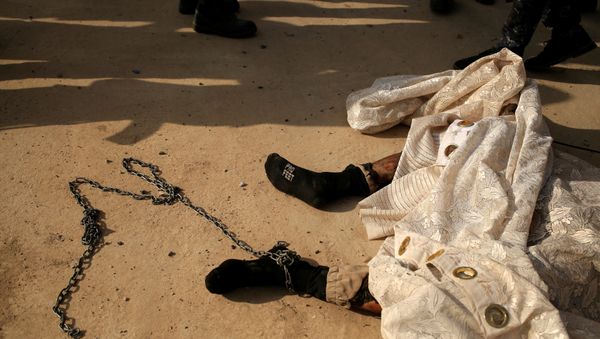 A chain is attached to the foot of a dead Islamic State fighter's body along a street of the town of al-Shura, which was recaptured from Islamic State (IS) on Saturday, south of Mosul, Iraq October 30, 2016 A chain is attached to the foot of a dead Islamic State fighter's body along a street of the town of al-Shura, which was recaptured from Islamic State (IS) on Saturday, south of Mosul, Iraq October 30, 2016 - Sputnik International