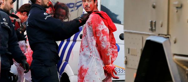 A demonstrator with red paint is detained by police officers during a protest against the Comprehensive Economic and Trade Agreement (CETA), a EU-Canada free trade agreement, outside the European Council in Brussels, Belgium, October 30, 2016. A demonstrator with red paint is detained by police officers during a protest against the Comprehensive Economic and Trade Agreement (CETA), a EU-Canada free trade agreement, outside the European Council in Brussels, Belgium, October 30, 2016. - Sputnik International