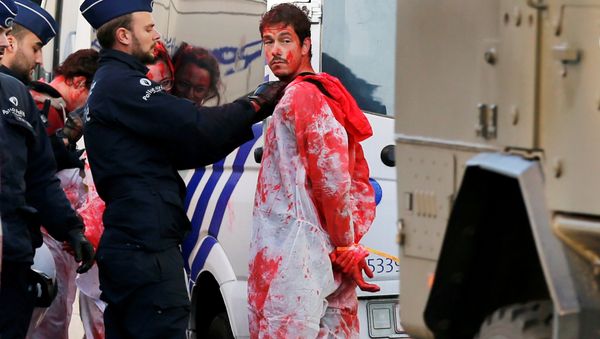 A demonstrator with red paint is detained by police officers during a protest against the Comprehensive Economic and Trade Agreement (CETA), a EU-Canada free trade agreement, outside the European Council in Brussels, Belgium, October 30, 2016. - Sputnik International