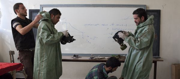 An Aleppo University student, shows Syrian citizens hows to put protective gear as he instructs them with rudimentary means of how to respond to a chemical attack, in the northern Syrian city of Aleppo (File) An Aleppo University student, shows Syrian citizens hows to put protective gear as he instructs them with rudimentary means of how to respond to a chemical attack, in the northern Syrian city of Aleppo (File) - Sputnik International
