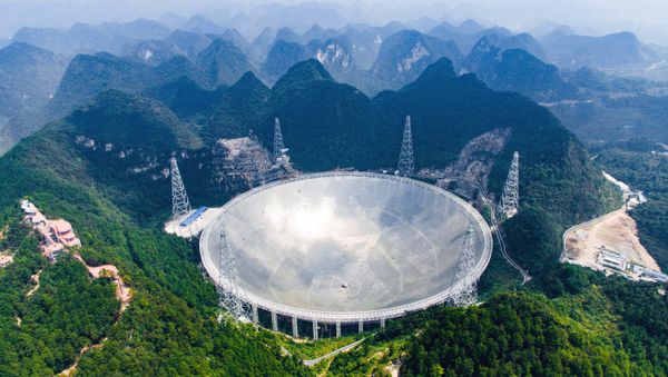 In this Saturday, Sept. 24, 2016 photo released by Xinhua News Agency, an aerial view shows the Five-hundred-meter Aperture Spherical Telescope (FAST) in the remote Pingtang county in southwest China's Guizhou province - Sputnik International