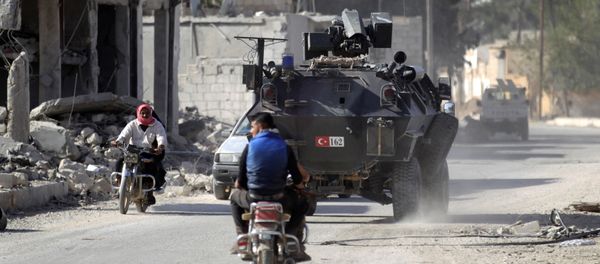 Men ride motorbikes past a Turkish armored carrier in the northern Syrian rebel-held town of al-Rai, in Aleppo Governorate, Syria, October 5, 2016 - Sputnik International
