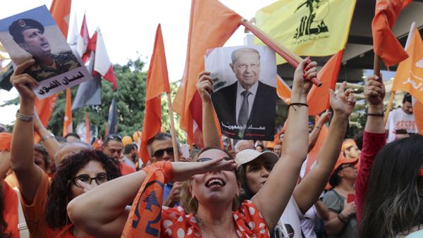 Supporters of Christian leader Michel Aoun hold his picture and Free Patriotic Movement, Lebanese flags and Hezbollah flag celebrate the election of the new President Michel Aoun, in Beirut, Lebanon, Monday, Oct. 31, 2016 Supporters of Christian leader Michel Aoun hold his picture and Free Patriotic Movement, Lebanese flags and Hezbollah flag celebrate the election of the new President Michel Aoun, in Beirut, Lebanon, Monday, Oct. 31, 2016 - Sputnik International