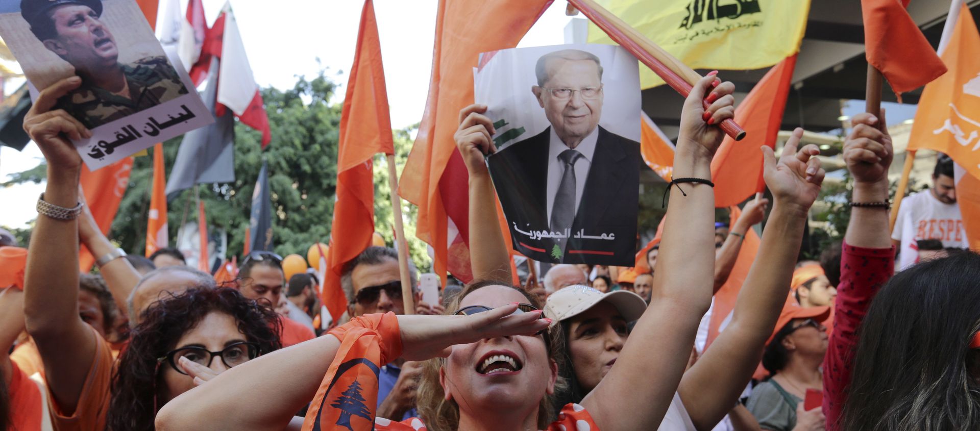 Supporters of Christian leader Michel Aoun hold his picture and Free Patriotic Movement, Lebanese flags and Hezbollah flag celebrate the election of the new President Michel Aoun, in Beirut, Lebanon, Monday, Oct. 31, 2016 - Sputnik International, 1920, 16.08.2020