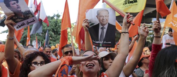 Supporters of Christian leader Michel Aoun hold his picture and Free Patriotic Movement, Lebanese flags and Hezbollah flag celebrate the election of the new President Michel Aoun, in Beirut, Lebanon, Monday, Oct. 31, 2016 Supporters of Christian leader Michel Aoun hold his picture and Free Patriotic Movement, Lebanese flags and Hezbollah flag celebrate the election of the new President Michel Aoun, in Beirut, Lebanon, Monday, Oct. 31, 2016 - Sputnik International