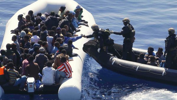 German Navy sailors surround a boat with more than 100 migrants near the German combat supply ship 'Frankfurt am Main' during EUNAVFOR Med, also known as Operation Sophia, in the Mediterranean Sea off the coast of Libya, Tuesday, March 29, 2016 German Navy sailors surround a boat with more than 100 migrants near the German combat supply ship 'Frankfurt am Main' during EUNAVFOR Med, also known as Operation Sophia, in the Mediterranean Sea off the coast of Libya, Tuesday, March 29, 2016 - Sputnik International