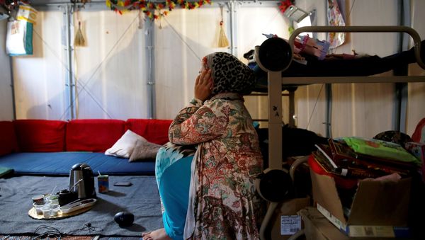 Syrian refugee Walaa, 26, sits inside her family's tent at the Souda municipality-run camp on the island of Chios, Greece, September 7, 2016. Syrian refugee Walaa, 26, sits inside her family's tent at the Souda municipality-run camp on the island of Chios, Greece, September 7, 2016. - Sputnik International