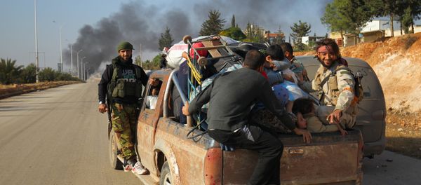 Rebel fighters ride a pick-up truck with civilians who fled areas of conflict in Dahiyet al-Assad, west Aleppo city, Syria October 30, 2016 Rebel fighters ride a pick-up truck with civilians who fled areas of conflict in Dahiyet al-Assad, west Aleppo city, Syria October 30, 2016 - Sputnik International