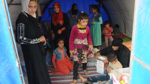 In this photo residents of Mosul and the nearby villages are seen being accomodated in the Hazir refugee camp In this photo residents of Mosul and the nearby villages are seen being accomodated in the Hazir refugee camp - Sputnik International