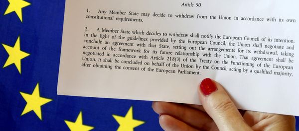 Article 50 of the EU's Lisbon Treaty that deals with the mechanism for departure is pictured near an EU flag following Britain's referendum results to leave the European Union, in this photo illustration taken in Brussels, Belgium, June 24, 2016. - Sputnik International