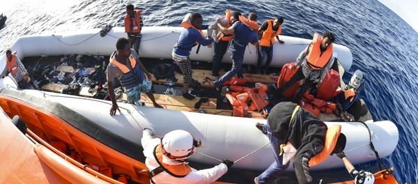 Men evacuate a rubber boat with the help of the crew of the Topaz Responder ship run by Maltese NGO Moas and the Italian Red Cross during a rescue operation of Migrants and refugees on November 3, 2016, off the Libyan coast in the Mediterranean Sea Men evacuate a rubber boat with the help of the crew of the Topaz Responder ship run by Maltese NGO Moas and the Italian Red Cross during a rescue operation of Migrants and refugees on November 3, 2016, off the Libyan coast in the Mediterranean Sea - Sputnik International