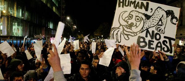 A man holds a placard reading Human not beast during a rally on November 2, 2016 in support of migrants living in a makeshift camp near the Stalingrad metro station in Paris, prior to its evacuation this week. A man holds a placard reading Human not beast during a rally on November 2, 2016 in support of migrants living in a makeshift camp near the Stalingrad metro station in Paris, prior to its evacuation this week. - Sputnik International