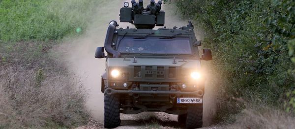 A vehicle of the Austrian army drives to patrol on the border for illegally entering migrants between Hungary and Austria in Nickelsdorf, Austria, Tuesday, Sept. 20, 2016 - Sputnik International
