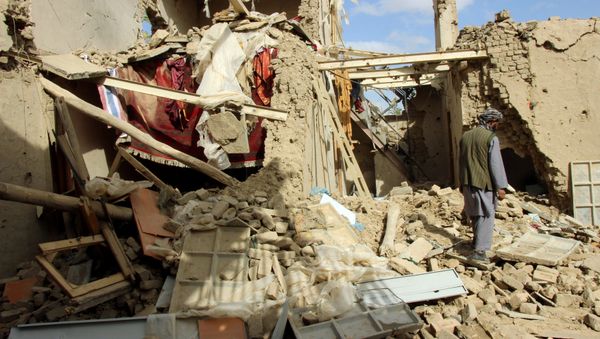 An Afghan man inspects a house destroyed during an air strike called in to protect Afghan and U.S. forces during a raid on suspected Taliban militants, in Kunduz, Afghanistan - Sputnik International