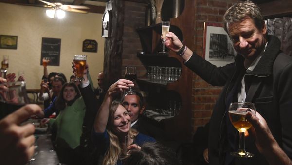 Newly elected French green party Europe-Ecologie-Les Verts (EELV) candidate for the 2017 presidential election Yannick Jadot (R) toasts as he celebrates with supporters after winning the EELV primaries, in a restaurant in Paris on November 7, 2016, Jadot won the second round of voting for the EELV primaries ahead of the 2017 French presidential election on November 7 - Sputnik International