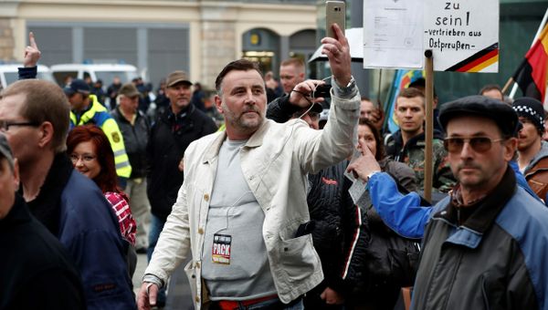 Lutz Bachmann (C), co-founder of the Pegida movement (Patriotic Europeans Against the Islamisation of the Occident), documents with his mobile phone as he takes part in a protest against German Chancellor Angela Merkel and her policy, on October 3, 2016, the German Unity Day, in Dresden, eastern Germany - Sputnik International