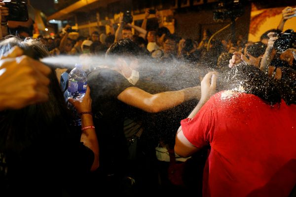 Protesters are pepper sprayed by police during a protest against what they call Beijing's interference over local politics and the rule of law, a day before China's parliament is expected to announce their interpretation of the Basic Law in light of two pro-independence lawmakers' oath-taking controversy in Hong Kong, China, November 6, 2016 - Sputnik International