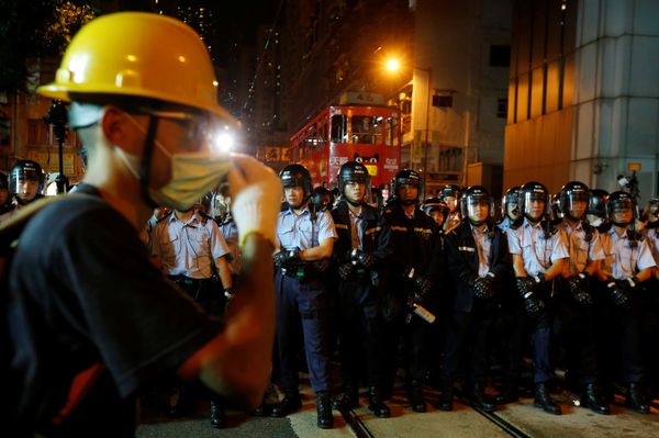 A protester stands in front of policemen outside China Liaison Office during a confrontation in Hong Kong, China November 6, 2016 - Sputnik International