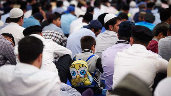 Members of the Ahmadiyya Muslim community prepare to listen to a speech by the fifth Caliph of the Ahmadiyya faith, Mirza Masroor Ahmad, during an annual three-day event, known as the Jalsa Salana, in Hampshire on August 21, 2015. Members of the Ahmadiyya Muslim community prepare to listen to a speech by the fifth Caliph of the Ahmadiyya faith, Mirza Masroor Ahmad, during an annual three-day event, known as the Jalsa Salana, in Hampshire on August 21, 2015. - Sputnik International