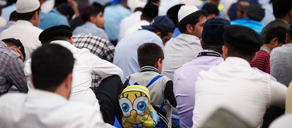 Members of the Ahmadiyya Muslim community prepare to listen to a speech by the fifth Caliph of the Ahmadiyya faith, Mirza Masroor Ahmad, during an annual three-day event, known as the Jalsa Salana, in Hampshire on August 21, 2015. Members of the Ahmadiyya Muslim community prepare to listen to a speech by the fifth Caliph of the Ahmadiyya faith, Mirza Masroor Ahmad, during an annual three-day event, known as the Jalsa Salana, in Hampshire on August 21, 2015. - Sputnik International