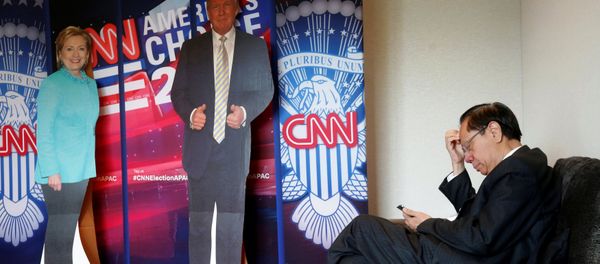A man checks his smartphone beside cardboard cutouts of U.S. presidential candidates Hillary Clinton (L) and Donald Trump, at an event held by the American Chamber of Commerce in Hong Kong, China November 9, 2016. A man checks his smartphone beside cardboard cutouts of U.S. presidential candidates Hillary Clinton (L) and Donald Trump, at an event held by the American Chamber of Commerce in Hong Kong, China November 9, 2016. - Sputnik International