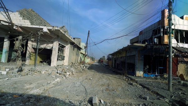 Damaged homes and shops due to clashes are seen through a glass window of a military vehicle in the town of Bashiqa, east of Mosul, Iraq, November 9, 2016 Damaged homes and shops due to clashes are seen through a glass window of a military vehicle in the town of Bashiqa, east of Mosul, Iraq, November 9, 2016 - Sputnik International