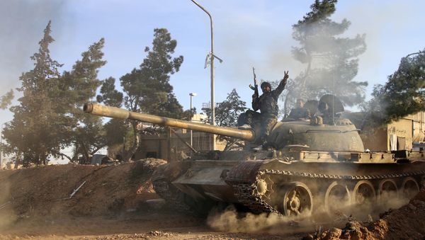 Volunteer fighter with the Syrian Government forces sits atop a tank in the province of Raqqa, Syria (File) - Sputnik International